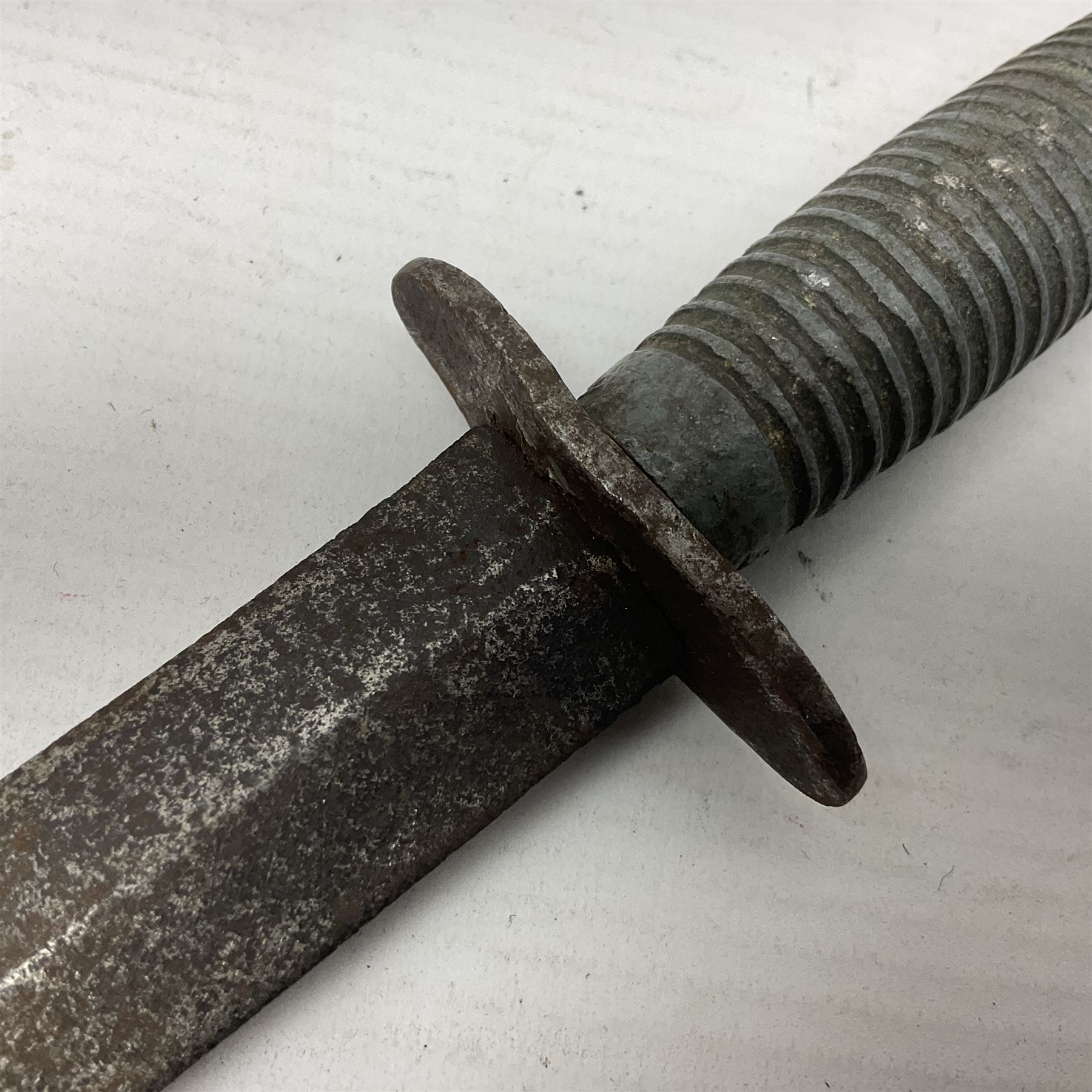 Fairburn Sykes style third pattern commando fighting knife, the 16cm double edged blade with central medial ridge, steel cross-piece marked with broad arrow and 'I', ribbed alloy grip L28cm overall (no scabbard); and Warriss Sheffield military pocket knife with two folding blades, marked with 'broad arrow 1953 and Oil The Joints' (2)