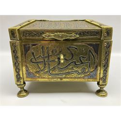 Late 19th century Damascus Cairoware Quran box, of square form with canted hinged cover, upon four circular pad feet, the brass exterior inlaid with silver and copper script and decorative detail, opening to reveal a marquetry lined interior, H15.5cm W19cm D19cm