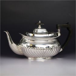 Late Victorian silver teapot, of oval part fluted form with ebonised wooden handle and fin...