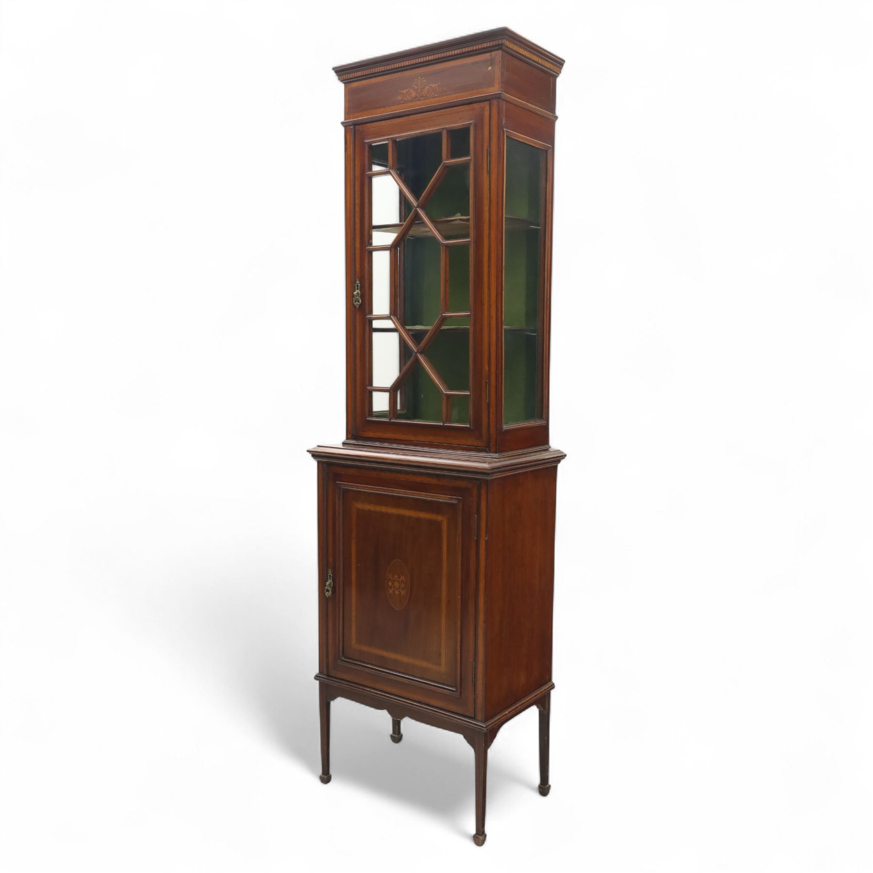 Edwardian inlaid mahogany display cabinet, the moulded cornice above an astragal glazed door enclosing two baize lined shelves, the lower section with a panelled cupboard door, raised on square tapering supports