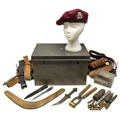 Assorted militaria including ten leather or canvas cartridge and other belts, maroon beret with 17th Lancers cap badge, modern bullet mould, leather and brass shot flask, two knives, shell cases, boomerang etc; in tin deed box