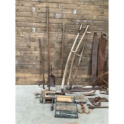 Large quantity of vintage hand tools including scales, scythes, saws etc
