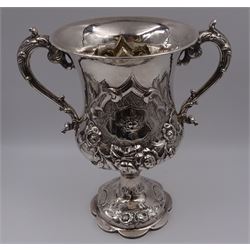 Victorian silver trophy cup, decorated in high relief with flower heads and scrolls, engraved to body 'Challenge Cup presented by Lieut Colonel W.A.White to the Head Quarters Rifle Club 1st V.B.P.W.O West Yorks Reg 1901' with twin acanthus capped scroll handles, upon knopped stem and lobed circular foot embossed with flower heads, hallmarked 	Robert Harper, London 1862, including handles H26.5cm