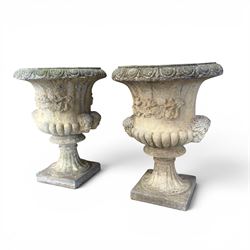 Pair of large cast stone garden urns, circular form with egg and dart border, tapering gadrooned bowl with cast handles and detail