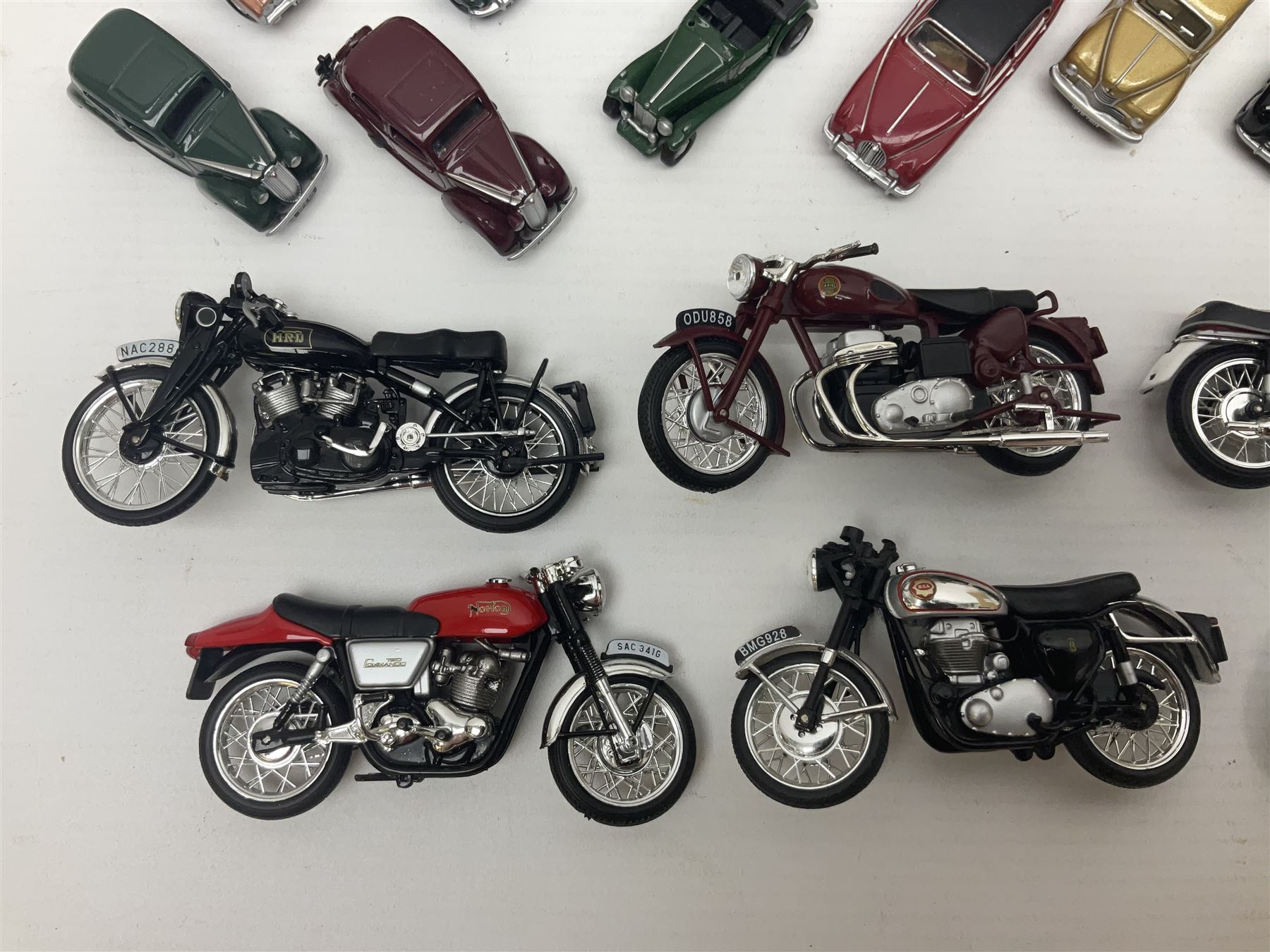Over forty 1:76 scale die-cast models of cars and commercial vehicles; some boxed; and eight small scale models of motorcycles; all unboxed