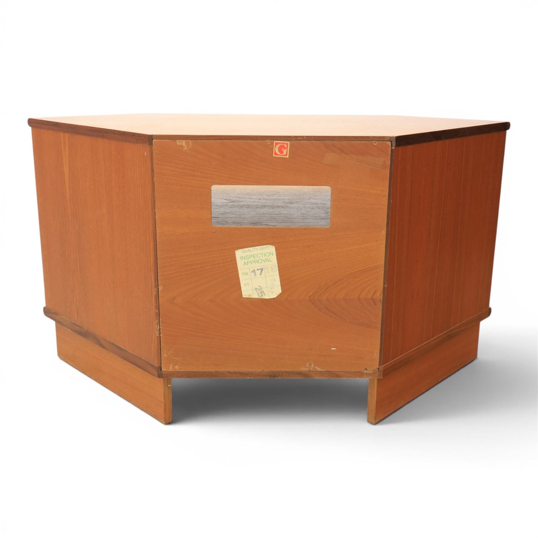 G-Plan - teak corner media unit, shaped top above a sliding central shelf above an open recess, flanked by further shelves, raised on a plinth base with a rear aperture for wires