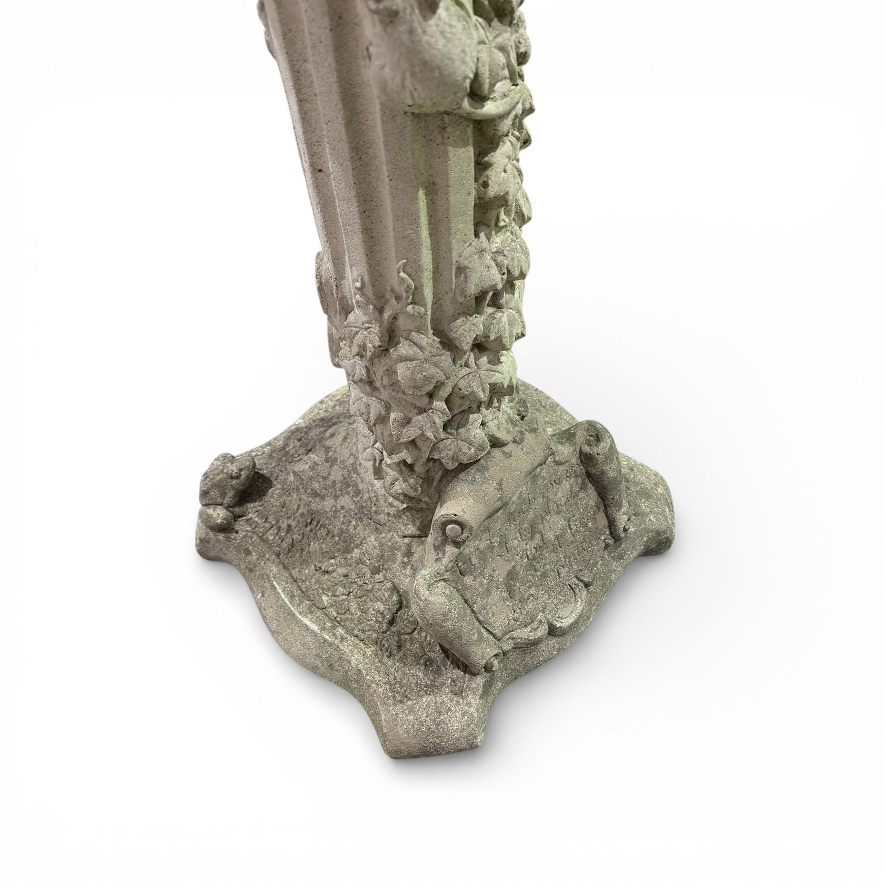 Cast stone bird bath on pedestal with cast iron water pump