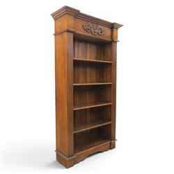 Hardwood open bookcase, fitted with five open shelves, applied carving to top facia