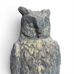 Pair of large composite stone garden statues modelled as standing horned owls, raised on circular bases