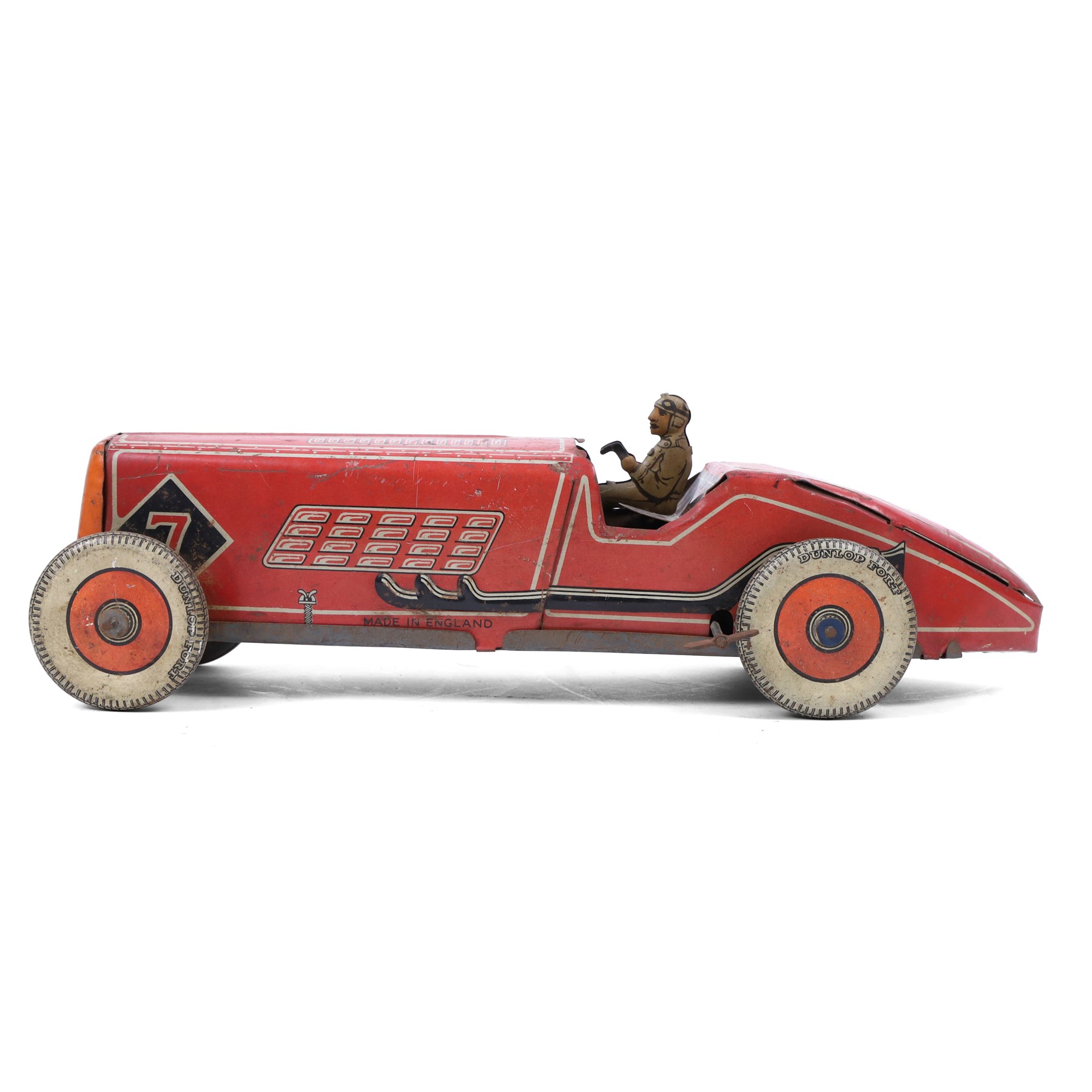 Mettoy tinplate clockwork racing car, the boat tailed red body with lithographed details, racing no. 7, with Dunlop Fort tyres, driver and key, H8cm, L32cm