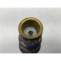 French enamelled candlestick, with floral decoration and gilt detail upon a blue ground, H14cm