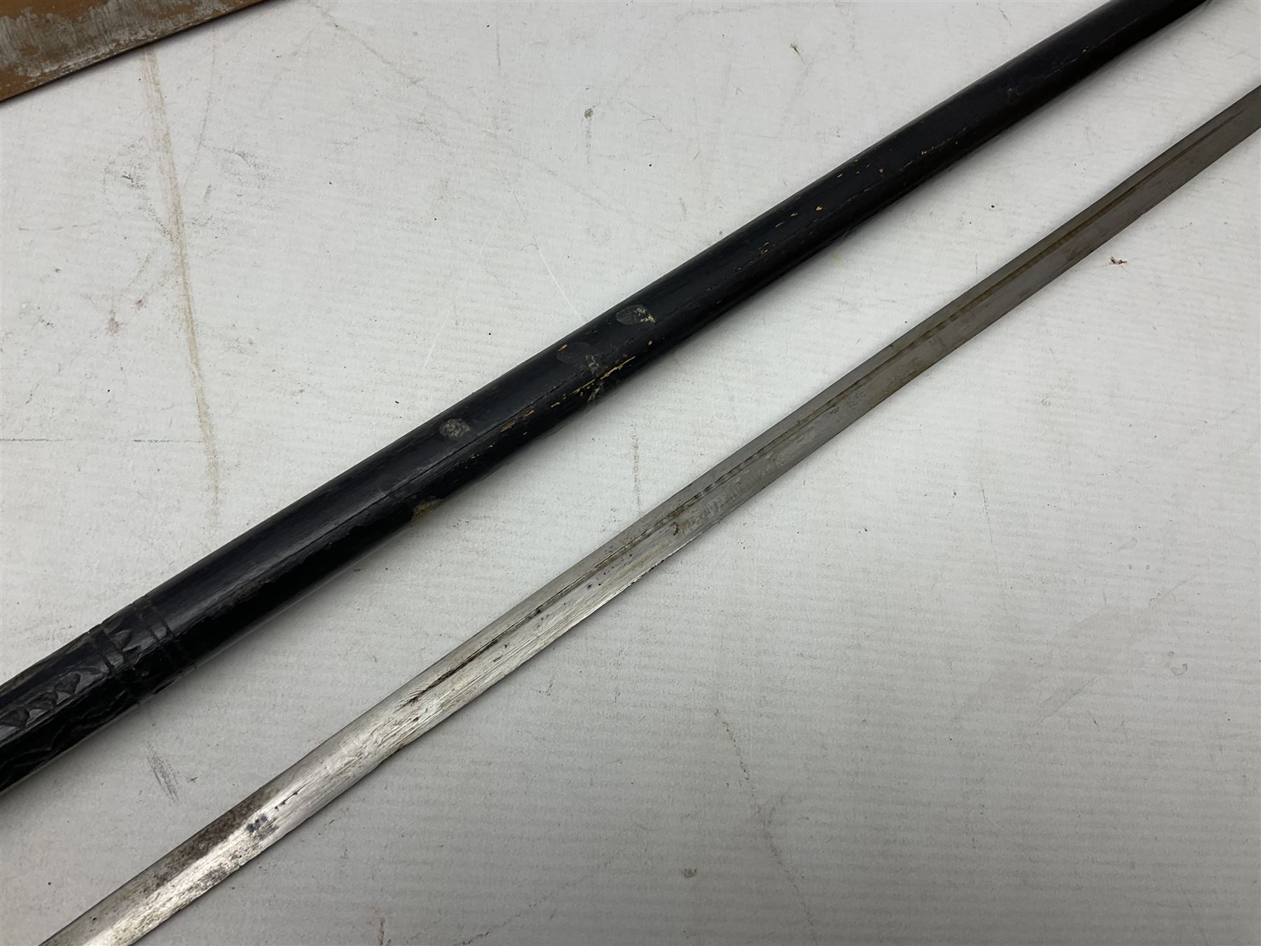 Early 20th century Indian ebonised sword stick, the 59.5cm blade with punched decoration and horn grip L94cm overall; and a reproduction Indian tulwar with scabbard (2)