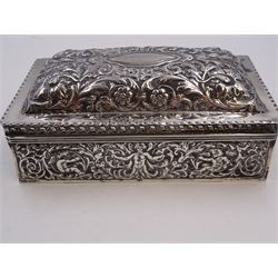 Victorian silver mounted cigarette box, of rectangular form, repousse decorated with ornate putti, floral, foliate and scroll detail, with a central blank cartouche to slightly domed, hinged cover, opening to reveal softwood lined compartmentalised interior,  hallmarked London 1888, maker's mark indistinct, H7cm