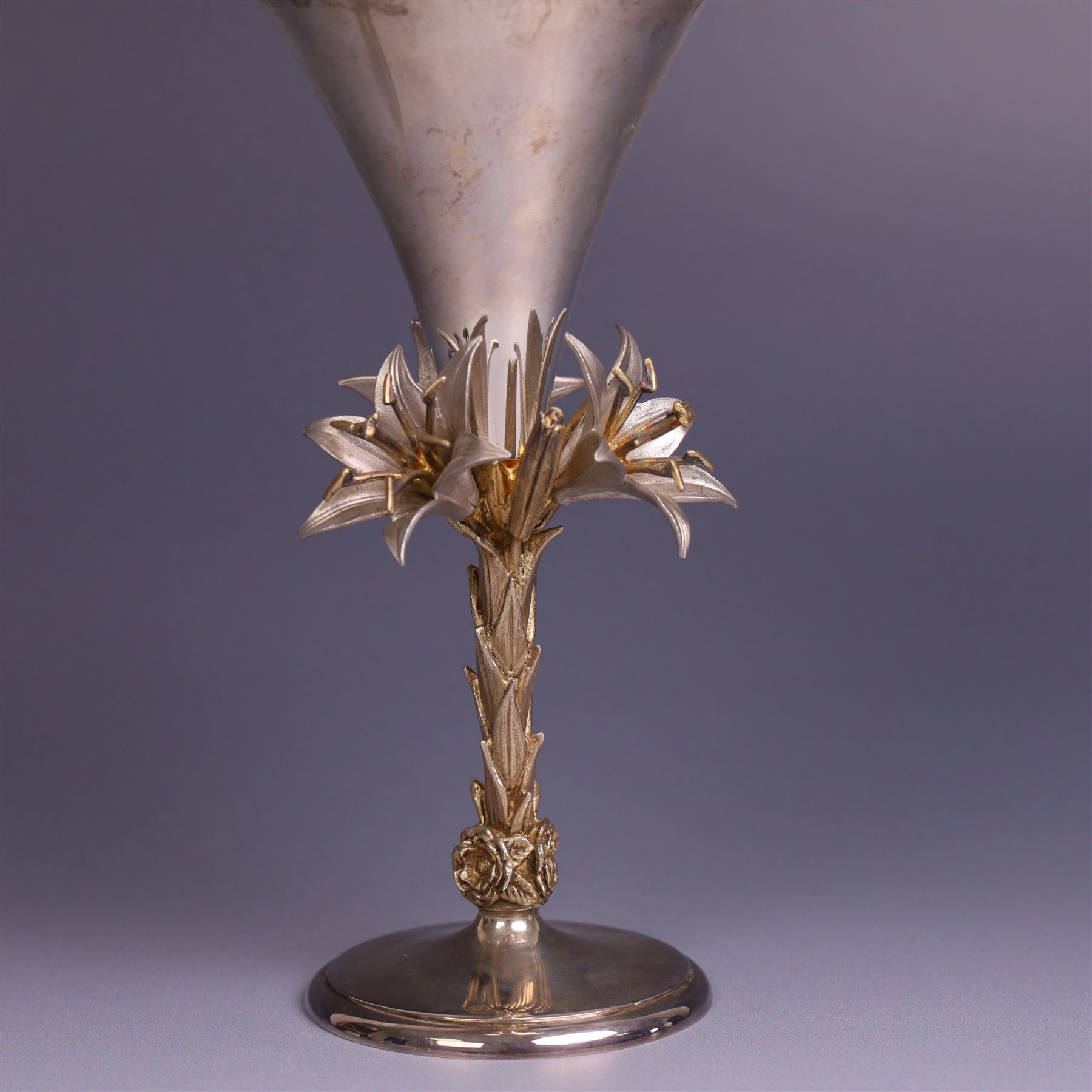 Modern limited edition silver goblet, 'made by order the provost and charter of Blackburn to commemorate the fiftieth anniversary of the cathedral in 1976 and its consecration in 1977' designed by Hector Miller for Aurum, the plain fluted cup, upon a stem of three lillies with parcel gilt highlihts and upon a circular foot, no. 2/750, hallmarked Hector Miller, London 1977, H17cm, boxed with certificate of authenticity