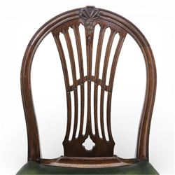 George III style set of six mahogany dining chairs, the arched backs with pierced and carved vase splats beneath carved husk and patera detail, drop-in upholstered seats covered in green leather with brass studded edging, raised on square section legs united by plain stretchers