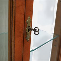 Sheraton design yew wood cabinet on stand, fitted with two glazed doors and two drawers, with lower shelf, illuminated interior