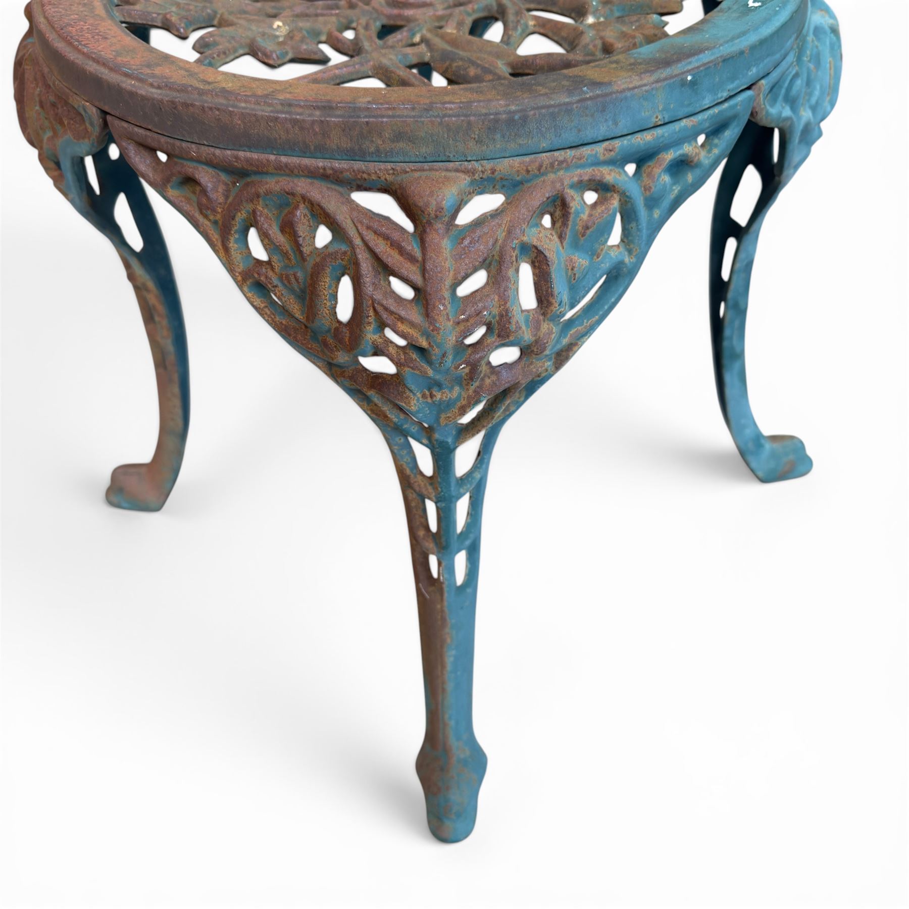 Cast iron garden table and four chairs, in the Art Nouveau style, with pierced floral and foliate decoration throughout, circular table raised on four cabriole legs with stretcher ring, chairs with shaped openwork backs and seats, in a weathered green finish