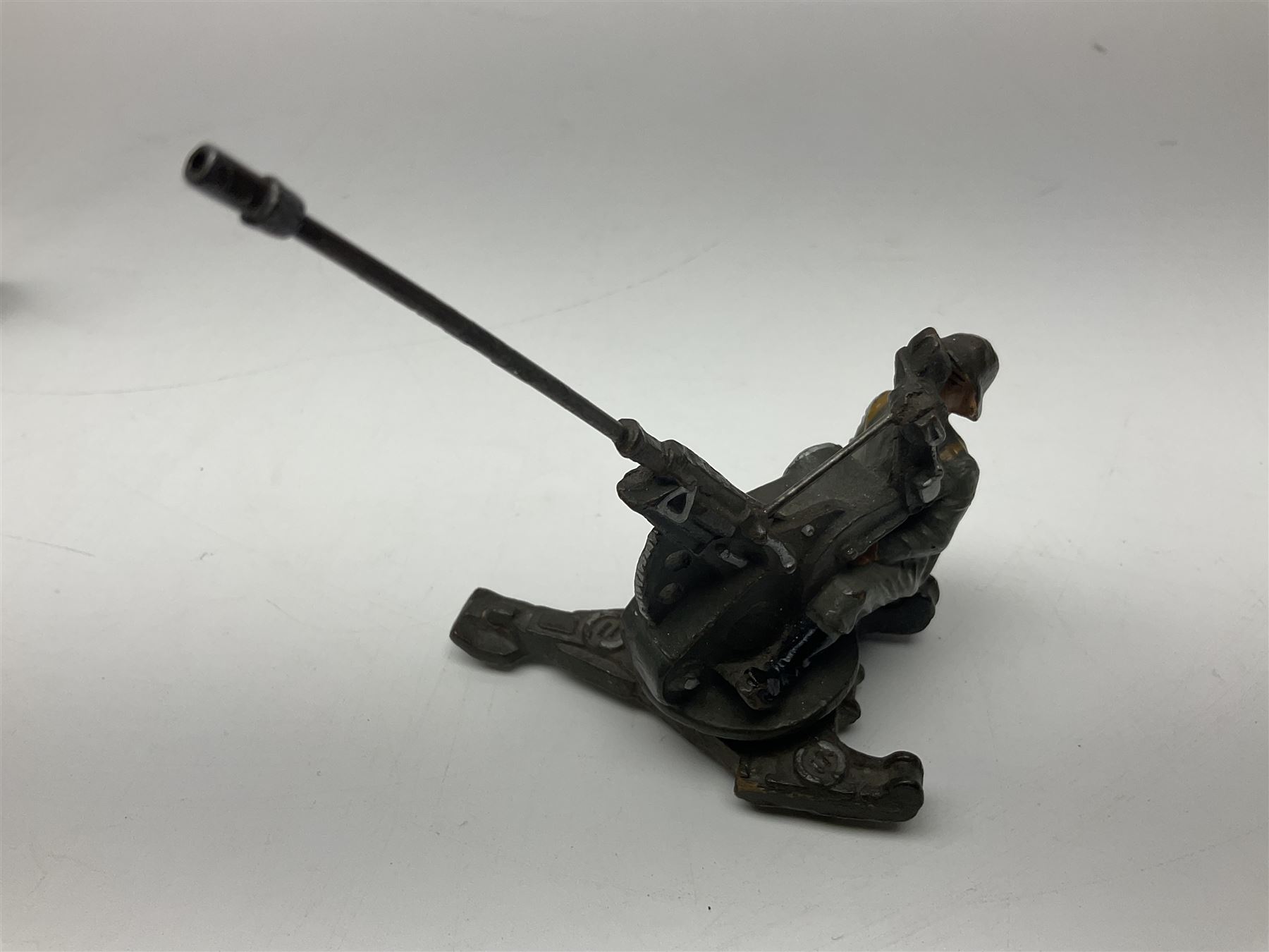 German Lineol Flak Artillery Gun on revolving base H11cm; four other Lineol WW2 German soldiers; and three Elastolin German soldiers including reclining radio operator (8)