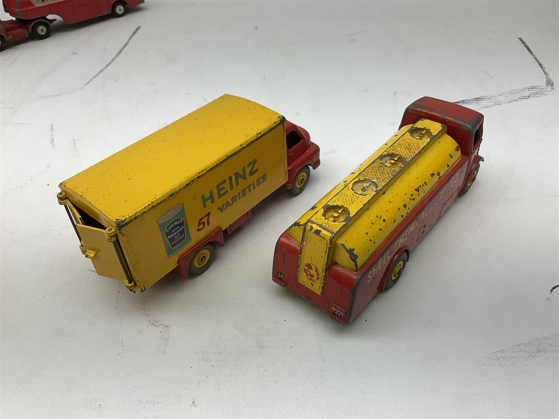 Dinky - five unboxed and playworn die-cast models comprising Supertoys Big Bedford Van 'Heinz' No.923; A.E.C. Monarch Thompson Tank; Maserati Racing Car No.231; H.W.M. Racing Car 23J; and Royal Mail Van; together with a Corgi Mobilgas Tanker (6)