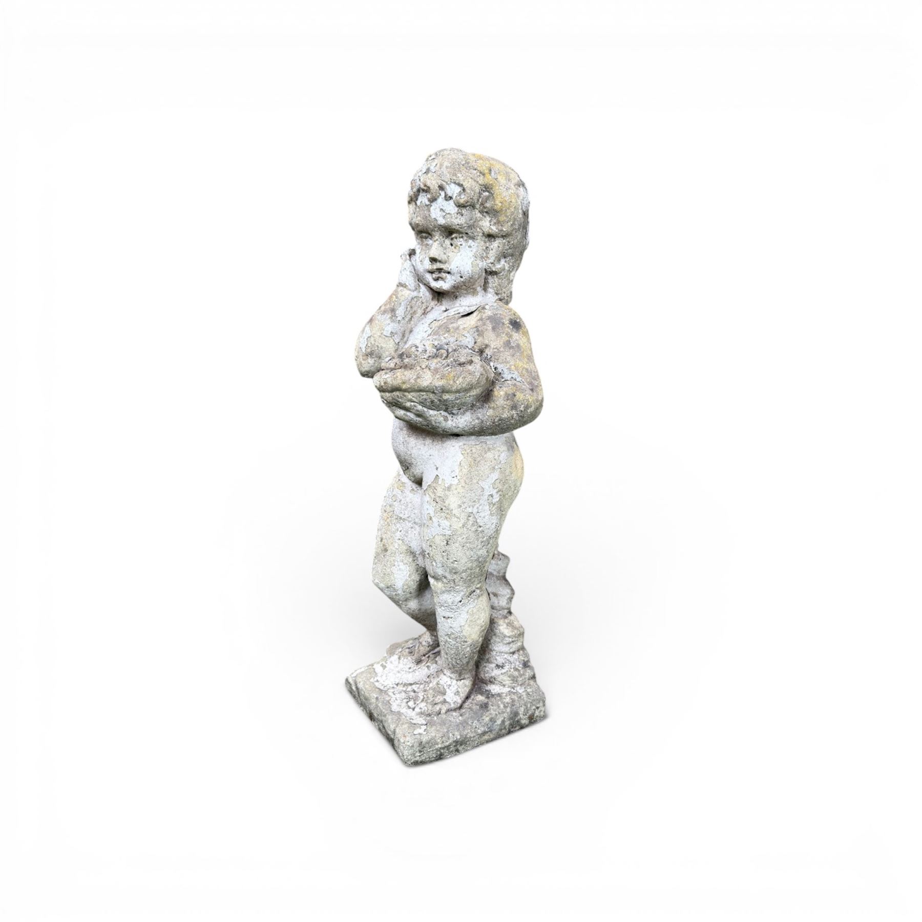Early composition stone figure of a boy with grape basket, original flakey white paint