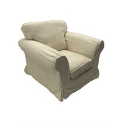 Traditional shaped armchair upholstered in white patterned loose cover