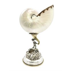 Modern limited edition silver mounted nautilus shell cup, no. 42/150, the pearlescent shell cup with silver-gilt strapwork to rim, upon a stem modelled as a putto supporting a gilt cornucopia and circular domed foot depicting Poseidon amongst swirling waves, hallmarked by St James House Company, London 1980,  H17.5cm