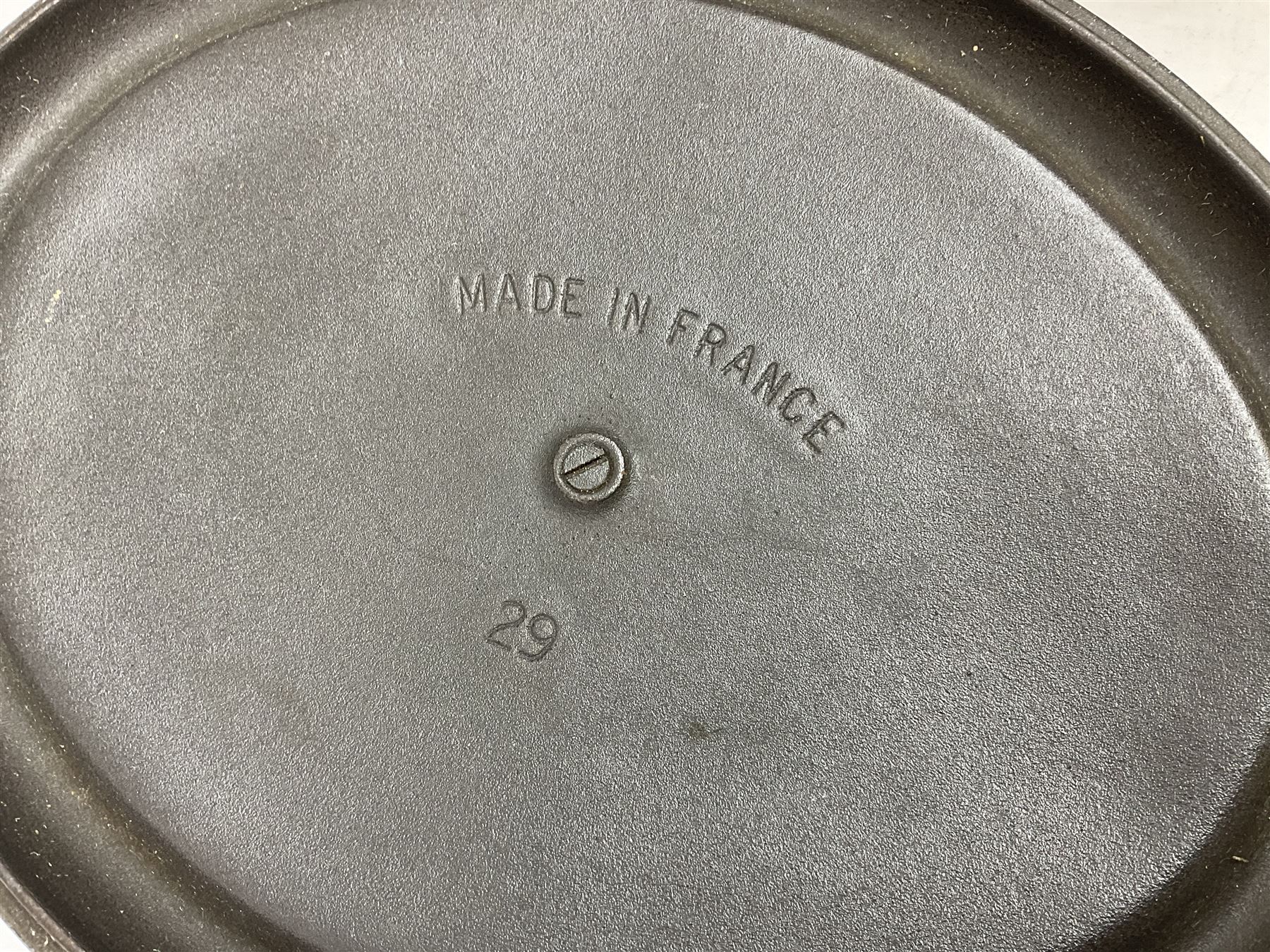 Emile Henry covered casserole dish of oval form in two tone brown and cream, no. 03.06, together with cast iron Nomar twin handled lidded casserole dish of oval form in navy, and other ovenware including Flintware ICTC, largest L35cm