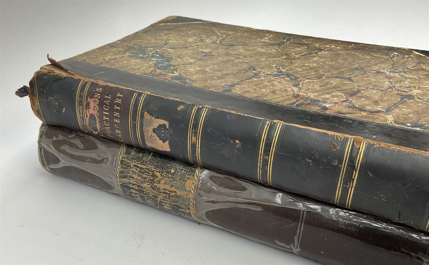 Newlands James: The Carpenter and Joiner's Assistant being a comprehensive treatise on the selection, preparation, and strength of materials and the mechanical principles of framing. Nd c1880. Later half leather binding and end papers; and Nicholson Peter (Thomas Tredgold): Practical Carpentry, Joinery, and Cabinet-Making. 1857. Half leather binding (2)
