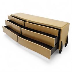 Contemporary maple veneered sideboard, serpentine glass top over six graduating Blum soft-close drawers, raised on curved black and gilt accented supports