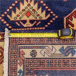 North West Persian Ardebil hand-knotted runner, indigo blue field composed of a repeating series of large stepped octagonal medallions enclosing a central hooked motif and stylized rosette, flanked by angular ivory and madder red latch hook devices, medallions linked by smaller geometric diamonds and serrated lozenges, guard borders with reciprocal motifs and main ivory border decorated with angular vines, with cotton fringe ends 