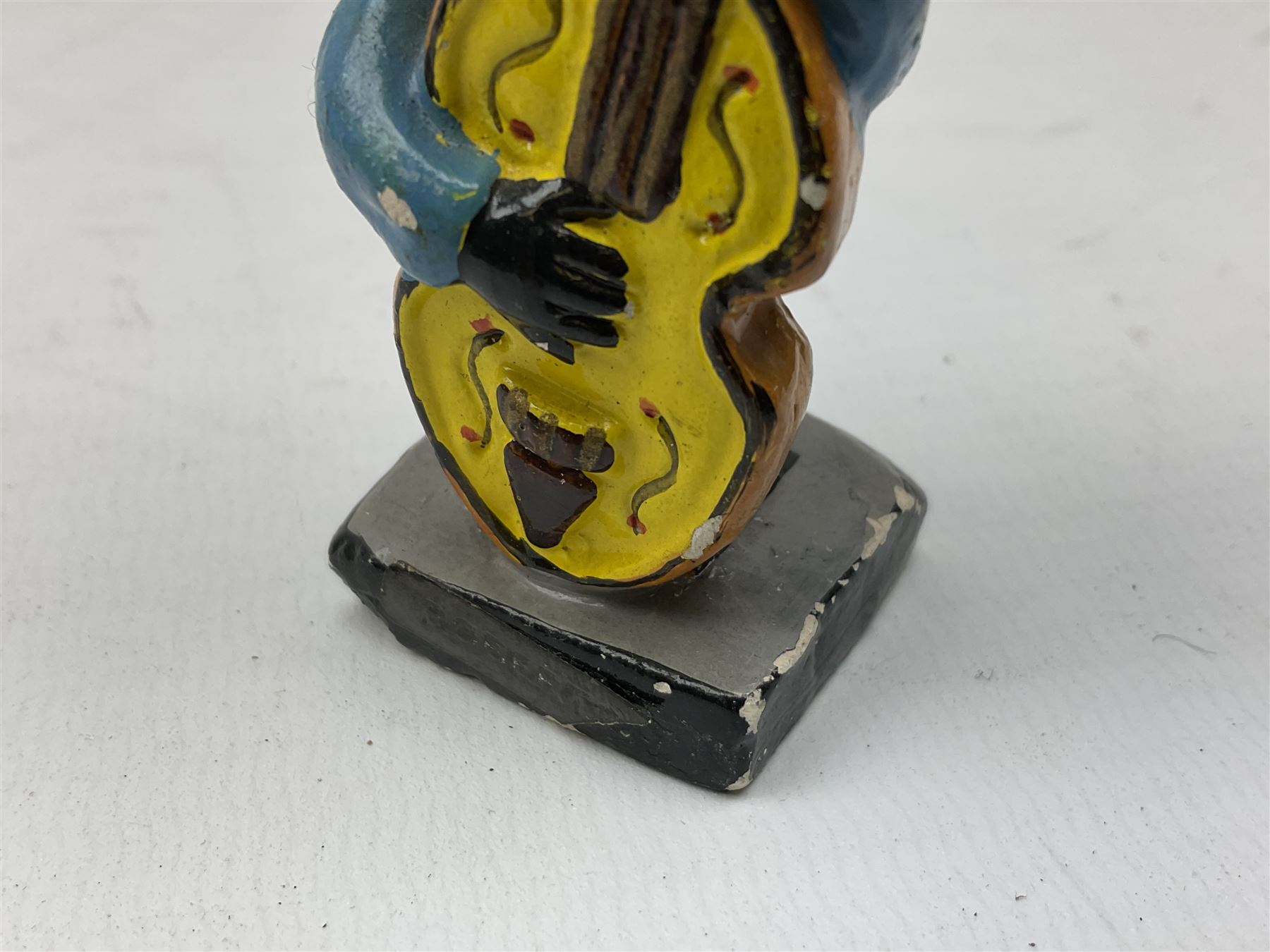 Robinson Jam plaster Golly band, including drummer and singer, H7.5cm

Originally handmade by mothers in Africa for their children from old fabric and cloth, the golly doll was adopted as the mascot and trademark for the Robertson's confectionery brand around 1910 after the company's founder John Robertson visited the US and noticed children playing with them. Robertson's Gollies have been collected by people across the UK and around the world for generations but garnered a contentious image in the 1980s because of links to racism. The trademark was removed from Robertson's branding in 2001.