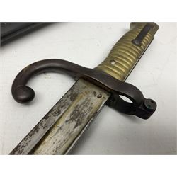 French Model 1866 Chassepot bayonet with 57cm curving fullered steel blade dated 1873 No.L63963; in steel scabbard with conforming number L71.5cm overall; and French St. Etienne Gras bayonet dated 1878 No.K10674 in steel scabbard numbered 79437 (2)