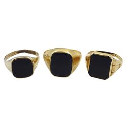 Two 14ct gold black onyx signet rings, stamped 585 and one other 9ct gold back onyx signet ring