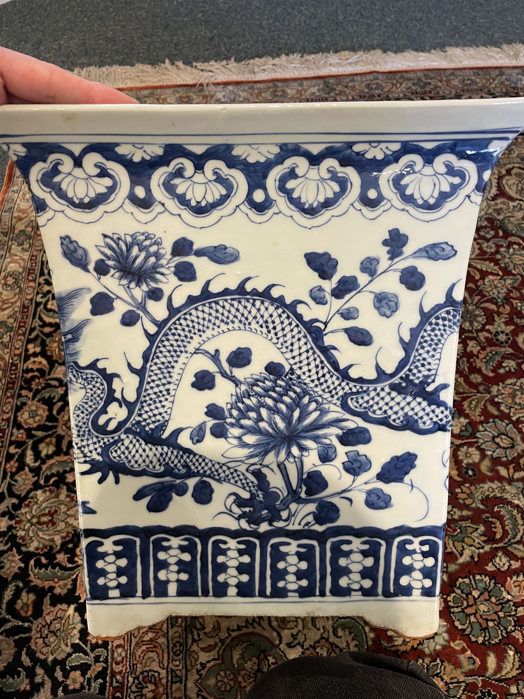 Chinese blue and white planter and stand, each of square slightly tapering and flared form, the planter decorated with two dragons and blossoming peonies, between stylised borders, the stand decorated with flower heads and vines, planter H30cm W29cm, stand H7cm D28.5cm