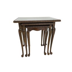 Early to mid-20th century nest of three walnut tables, with inset glass tops, on cabriole supports