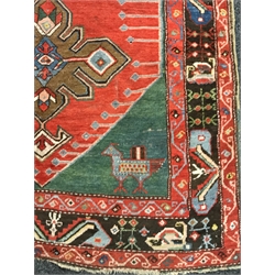Turkish red ground rug, the field decorated with three large stylised stars, two bird motifs to one end, 256cm x 130cm