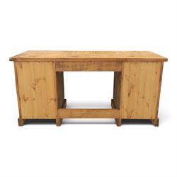 Indigo Furniture - rustic oak twin pedestal desk, rectangular plank top, with central frieze drawer, the fixed pedestals with three drawers and metal cup handles, raised on a plinth base