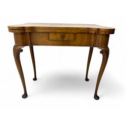 Georgian walnut fold-over card table, shaped rectangular top opening to reveal a baize-lined surface, supported by a concertina pull-out rear mechanism, frieze fitted with single drawer, raised on cabriole supports with foliate carvings terminating in pad feet