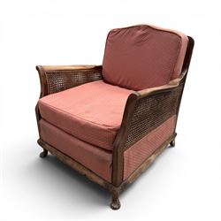 Early 20th century French style bergère conservatory suite, canework back and sides with red upholstered loose seat cushions, on cabriole feet