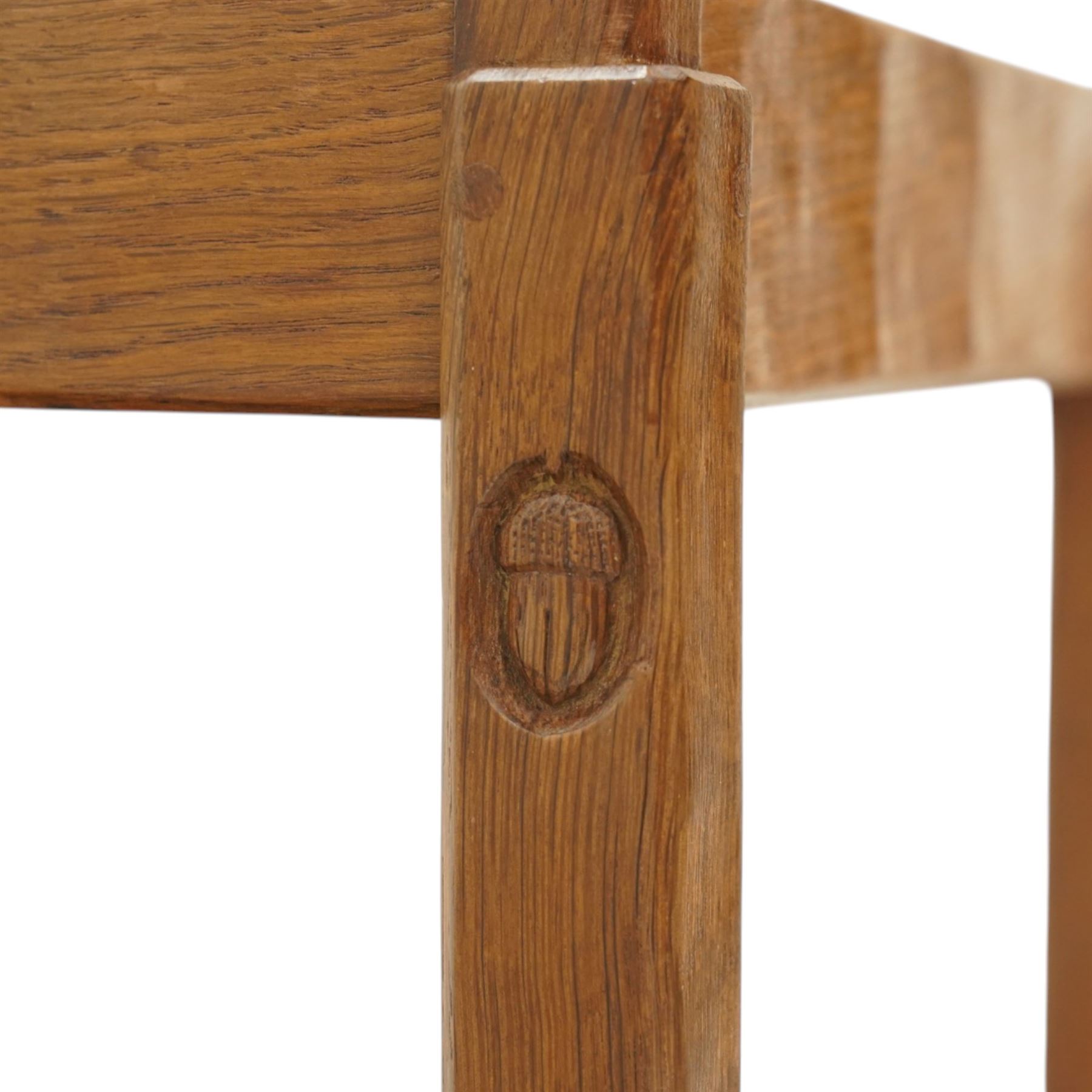 Acornman - oak two tier tea trolley, rectangular adzed top and lower section, with drawer raised on square supports terminating in castors, with carved acorn signature, by the workshop of Alan Grainger of Brandsby