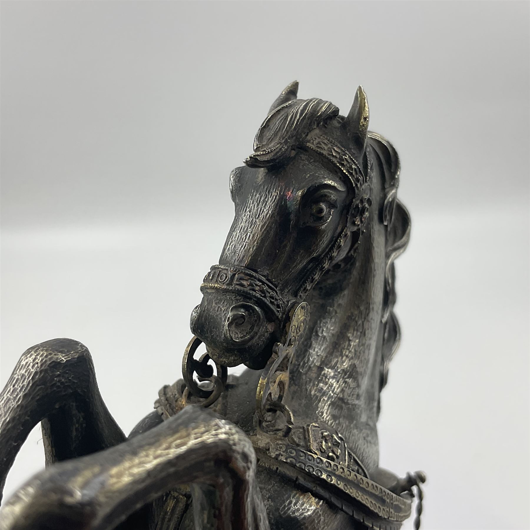 Modern silver model of a rearing horse, with ornate parcel gilt saddle and bridle, mounted upon a rectangular base, decorated with malachite panels to each side and upon four gilt bun feet, horse stamped 925, overall H14.5cm