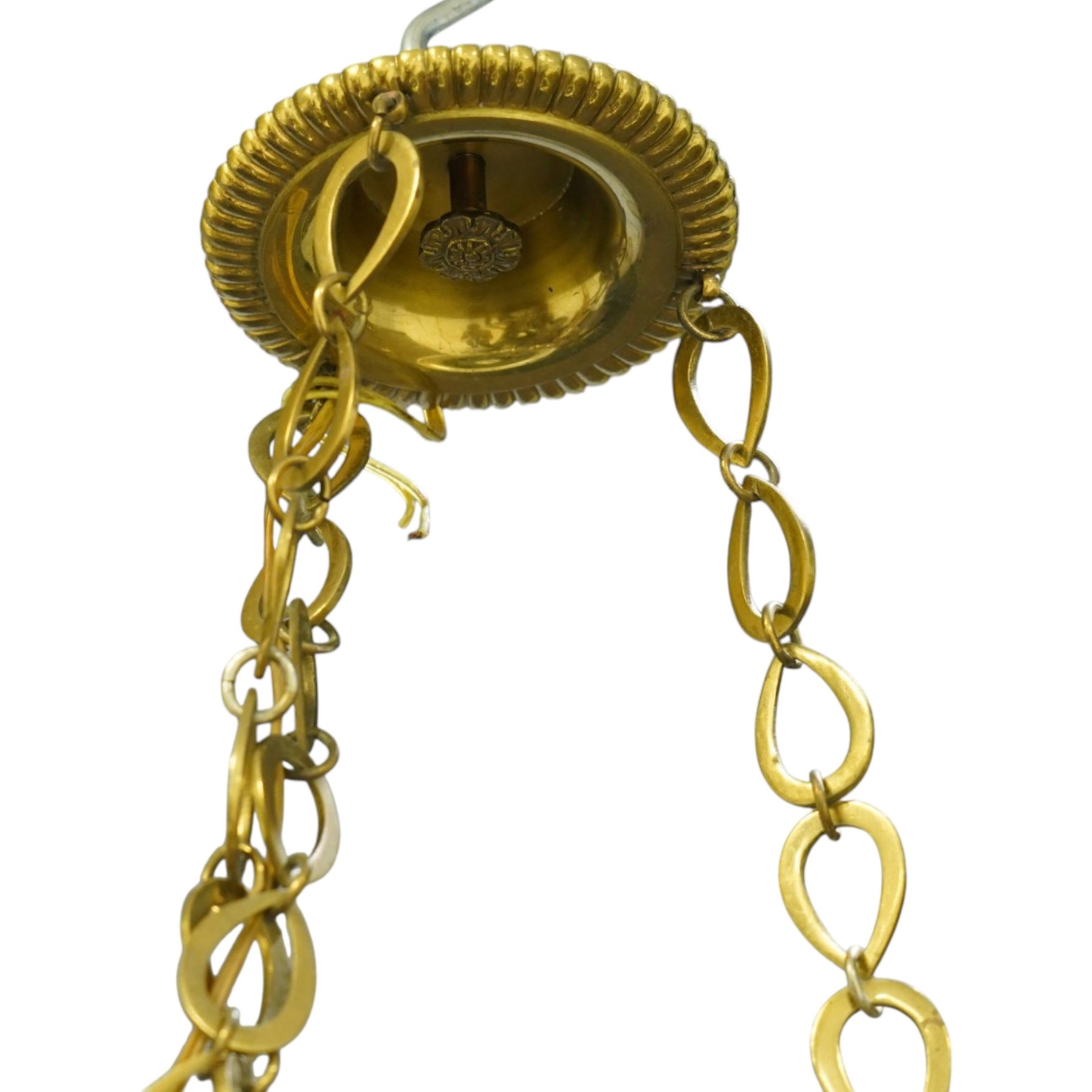 Regency Revival chromium-plated and gilt-brass nine-light chandelier of Neoclassical design, the dished central bowl applied with substantial gilt winged cherub-mask mounts and issuing nine scrolling branches with circular drip pans and faux candle sleeves, over a spherical terminal with gilt-metal gadrooned flower-petal collar and ring, max. diameter 75cm