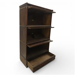 Globe Wernicke - early 20th century three sectional stacking library bookcase, two glazed sections above a panelled section, on a plinth base with inbuilt drawer