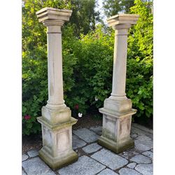 Set of four cast stone architectural columns, tapering form, on square plinth bases