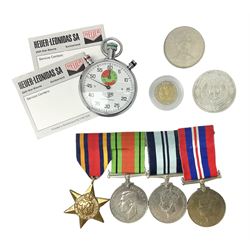 Four WWII medals comprising Burma Star, India 1939-45, and two defence medals 1939-1945 together with a Heuer stopwatch and three coins
