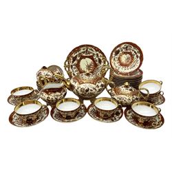 20th century German part tea service decorated in an oriental design with gilt detail, comprising teapot, twin handled covered sucrier, milk jug, eleven cups, twelve saucers, twelve dessert plates and two cake plates (40)