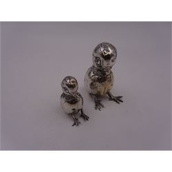 Two Edwardian silver novelty pin cushions, each modelled as a hatching chick, with cushioned backs, both hallmarked Birmingham 1910, maker's mark indistinct, largest H5.7cm