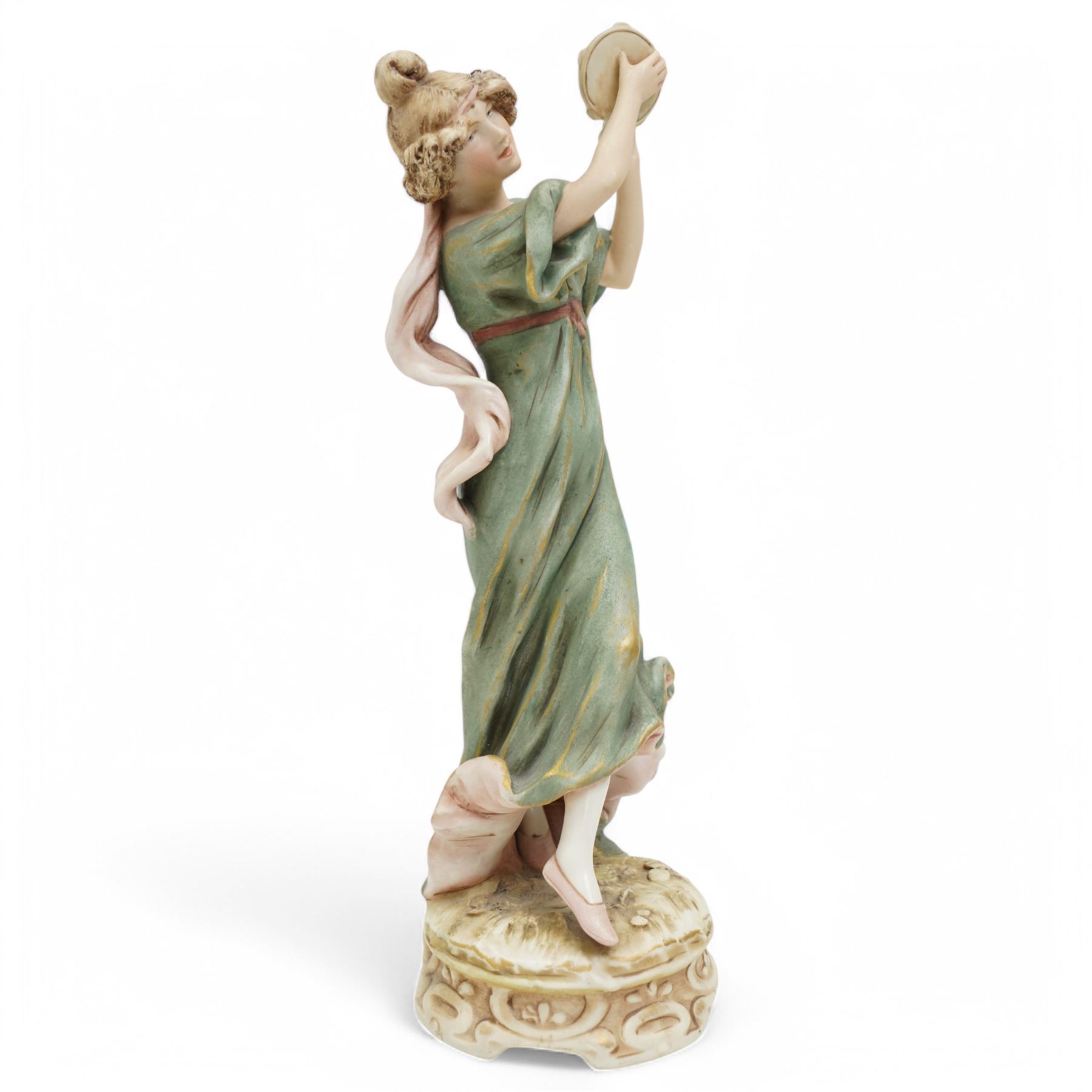 Royal Dux female figure holding a tambourine in burnished gilt and on circular naturalistic base, model no.1430 H27cm