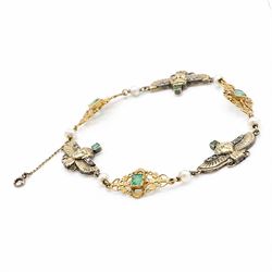 Early 20th century French 18ct gold Egyptian Revival bracelet, three winged sphinx motif panels, each set with a square cut emerald and four rose cut diamonds, spaced by six white / cream pearls and three scrolling openwork links, each centred with a square cut emerald, French assay marks
