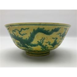 Pair of Chinese famille jaune bowls, decorated in green enamel with a dragon chasing a flaming pearl amongst clouds, upon a yellow ground, the interior decorated to centre with dragon, with six character mark beneath, D17.5cm